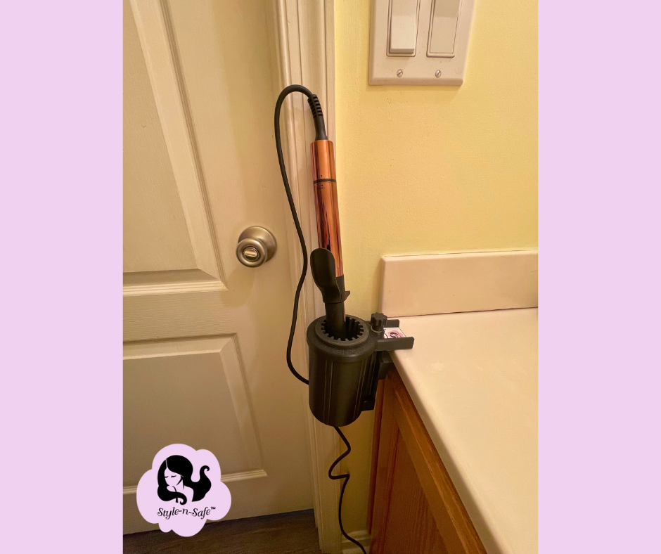 PIcture of Clampable curling iron holder installed on a bathroom counter edge holding a curling iron