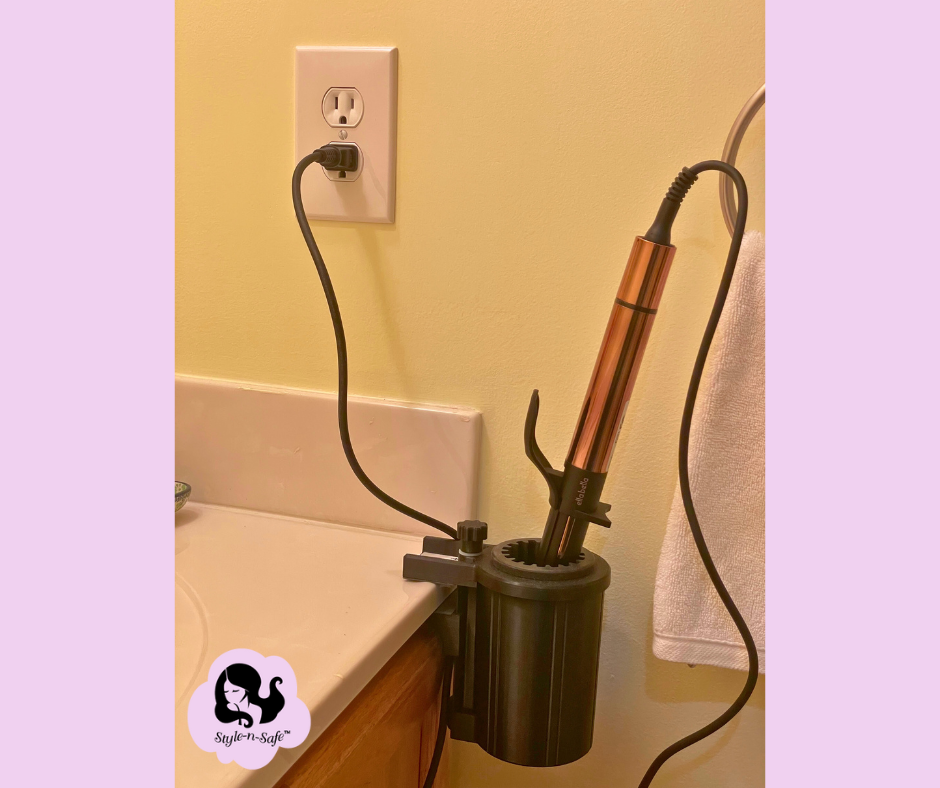 PIcture of Clampable curling iron holder installed on a bathroom counter edge holding a curling iron